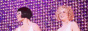 Roxie and Velma from Chicago dancing in fron of a wall of pink bulbs during the Nowadays musical number